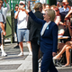 Hillary Clinton greets onlookers outside her daughter’s apartment building after becoming unwell at Sunday’s 9/11 anniversary ceremony. Image via Associated Press.